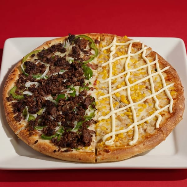 Half beef and vegetable pizza, half corn and mayonnaise pizza on a white plate.
